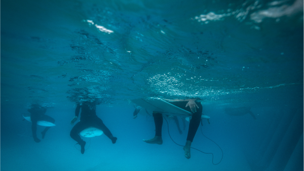surfers floating in the Wavegarden pool at The Wave